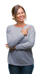 Middle age senior hispanic woman over isolated background cheerful with a smile of face pointing with hand and finger up to the side with happy and natural expression on face looking at the camera.