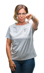Fototapeta premium Middle age senior hispanic woman wearing glasses over isolated background looking unhappy and angry showing rejection and negative with thumbs down gesture. Bad expression.