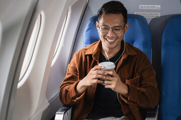 Successful business man, Airplane, travel, enjoying comfortable flight while sitting in the airplane cabin.