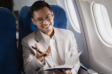 Successful business man, Airplane, travel, enjoying comfortable flight while sitting in the airplane cabin.