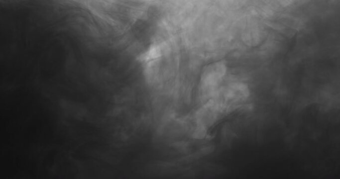 Colored ink clouds floating slowly in the water 
