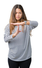 Young beautiful brunette woman wearing stripes sweater over isolated background Doing time out...