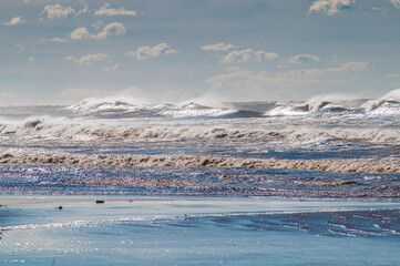 Waves breaking on the shore in brazil