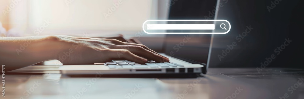 Poster closeup of a hand typing on a laptop keyboard with a search bar overlay, showing modern technology a