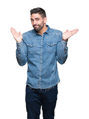 Fototapeta premium Young handsome man over isolated background clueless and confused expression with arms and hands raised. Doubt concept.
