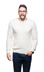 Fototapeta premium Young handsome man wearing glasses over isolated background sticking tongue out happy with funny expression. Emotion concept.