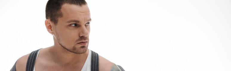 A man with a sharp gaze looks off to the side.