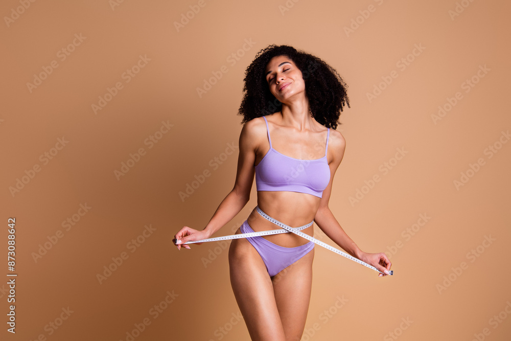 Sticker No filter portrait of stunning model girl measure waist closed eyes isolated on beige color background