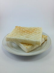 Toasts: Sliced Bread on a White Background. Crispy and Golden Slices Perfectly Captured in a Minimalist Setting, Ideal for Breakfast or Snack Concepts