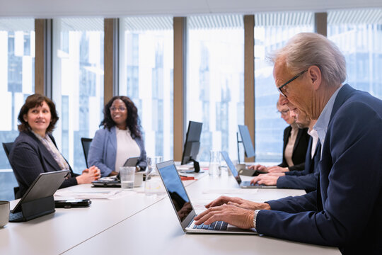 Multiracial business people working over conference table in office