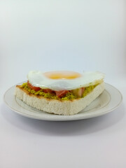 Mashed Avocado, Diced Tomato, Sunny Side Up on Toast: Flavorful and Colorful Breakfast Combination Featuring Fresh Ingredients, Perfectly Presented on a Clean White Background