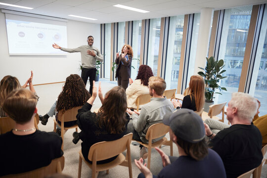 Businessman sharing ideas with colleagues during meeting in office