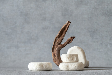 Empty stone podium, pieces of snag on grey background. Minimalist eco backdrop. Round natural rocks...