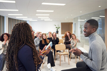 Multiracial corporate colleagues applauding for achievements in office