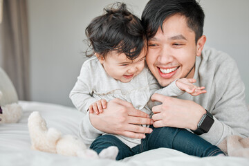 Asian family, father and baby in bed for playful, bonding together and child care with single parent in home. Bedroom, little girl and proud dad for support, security and hug with daughter in house