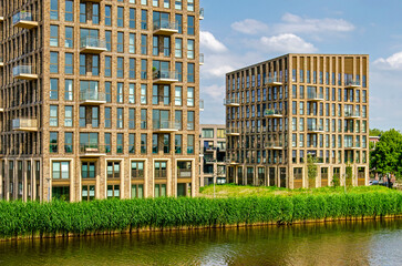 Rotterdam, The Netherlands, June 6, 2024: two rcently completed residential buildings on the banks of Schie canal in Overschei neighbourhood