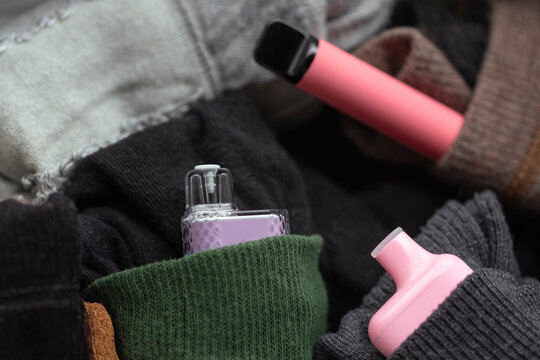 Close-up of electronic cigarettes in bag pockets