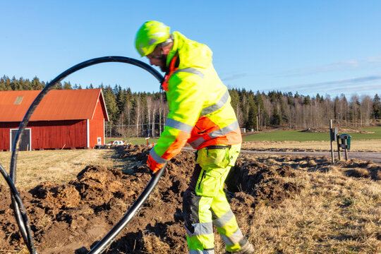 Maintenance engineer installing cable on sunny day