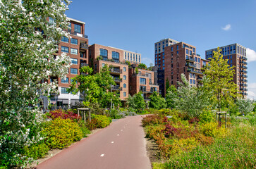 Rotterdam, The Netherlands, June 19, 2024: bicycle path through Tuschinski Park with Little C...