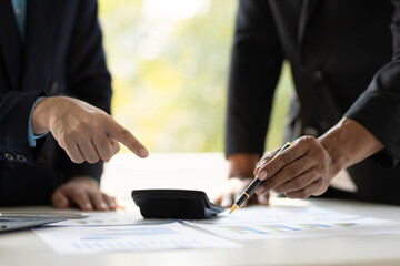 Business consulting meeting is discussing analysis financial data and business growth charts to...