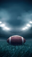 Illuminated stadium under misty night sky with American football on grass Vertical Mobile Wallpaper