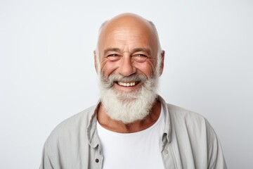 Fototapeta premium Smiling bearded mature man portrait against white background