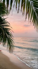 Fototapeta premium Serene beach at sunrise with pink and orange sky, palm leaves Vertical Mobile Wallpaper