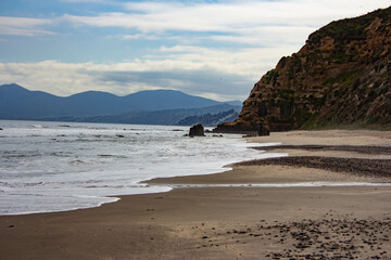 Fototapeta premium On the shore of Playa Quirilluca while the waves come very close