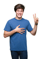 Young handsome man wearing blue t-shirt over isolated background Swearing with hand on chest and...