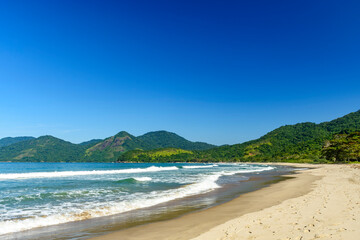 The sea and the beach next to the mountains and forest of Bonete beach on the island of Ilhabela