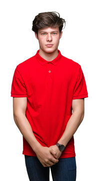 Young handsome man wearing red t-shirt over isolated background Relaxed with serious expression on face. Simple and natural looking at the camera.