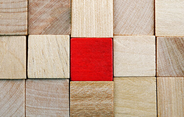 red cubes among a pile of wooden cubes
