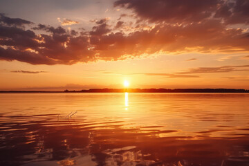 Obraz premium Tranquil Sunset Over a Calm Lake with Vibrant Colors Reflected on the Water Surface