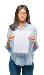 Young asian woman over isolated background holding blank paper with a confident expression on smart face thinking serious