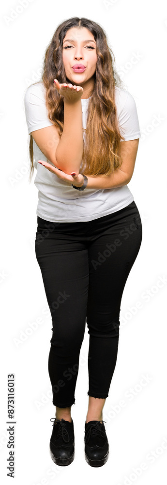 Wall mural Young beautiful woman wearing casual white t-shirt looking at the camera blowing a kiss with hand on air being lovely and sexy. Love expression.