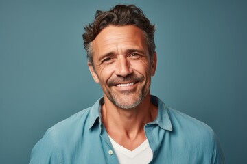 Obraz premium Portrait of a satisfied man in his 40s donning a trendy cropped top in front of pastel blue background