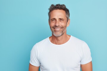 Obraz premium Portrait of a satisfied man in his 40s donning a trendy cropped top over pastel blue background