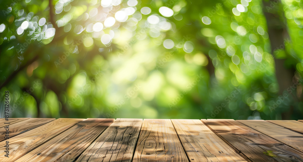 Poster a wooden table with a view of trees and a bright sun blurred background, wooden table top and soft s