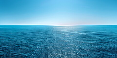 Fototapeta premium Beautiful Ocean View with Clear Blue Sky, Wide Shot of Sea Surface with Gentle Ripples and Sparkling Water Under Bright Sunlight, Creating an Enchanting Scene for Endless Adventure