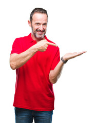 Middle age hoary senior man over isolated background amazed and smiling to the camera while presenting with hand and pointing with finger.