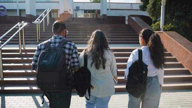 Indian students going to class, rear view