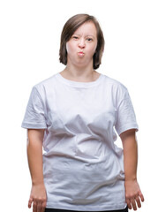 Fototapeta premium Young adult woman with down syndrome over isolated background puffing cheeks with funny face. Mouth inflated with air, crazy expression.