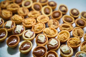 Baked sweet nut halves filled with cream and chocolate fudge