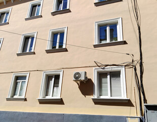 Building facade. Sale, rental cheap apartments. Housing development. Cityscape. City life. Real estate. Mortgage concept. Condos. Interest Rate Increase. Flat. Air conditioner on wall. Electric wires.