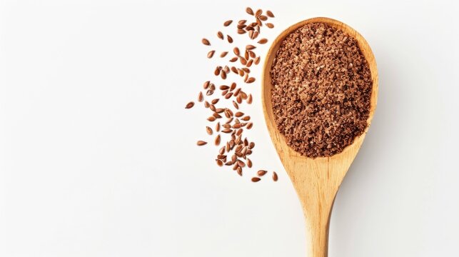 Brown flaxseed or linseed powder on wooden spoon against white background