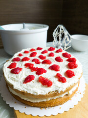 The process of making cooking cake with raspberries in the kitchen. Home cooking