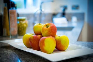 apples on a plate in a kitchen 