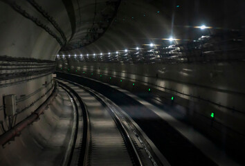 The dim lights of an empty subway tunnel