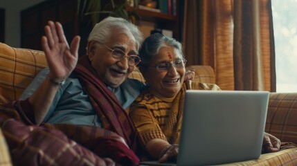 Senior couple, home laptop, video call, voip, chat, and conversation. Happy man, woman, and wave hello online, in chat, and retired on sofa.