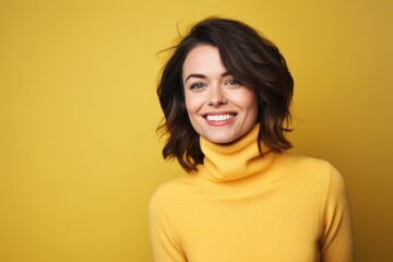 Fototapeta premium Portrait of a joyful woman in her 30s wearing a classic turtleneck sweater on soft yellow background